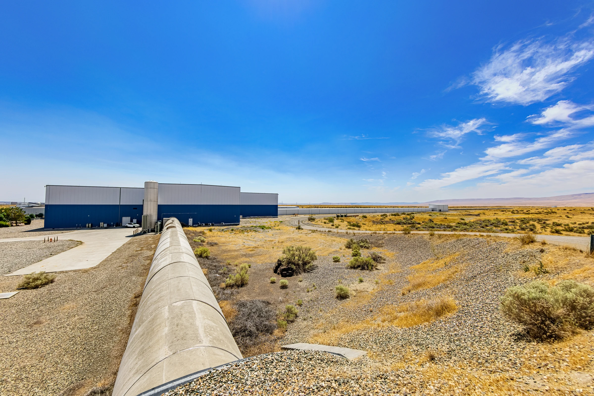 Aerial photograph of the LIGO Hanford gravitational-wave observatory in Washington, with its long detector arms extending across the landscape.