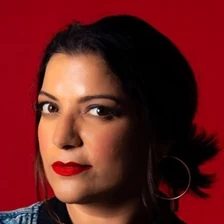 Aditi Mittal in her official festival-profile portrait against a red background