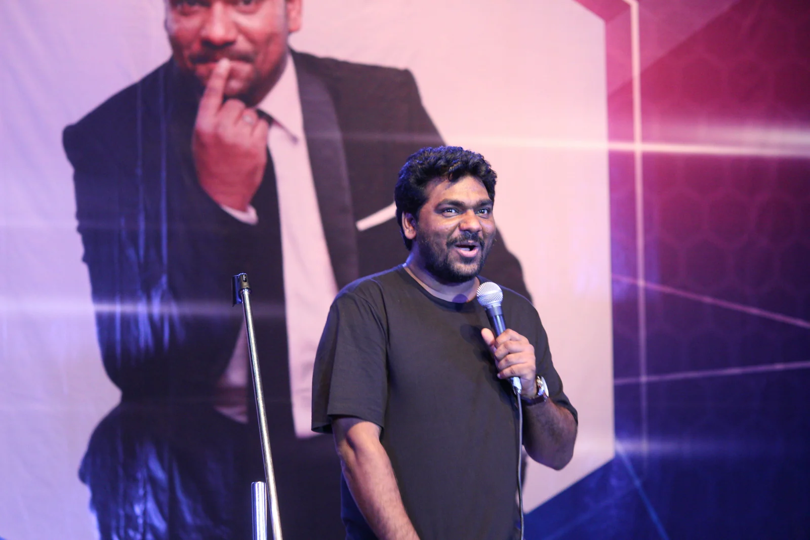 Zakir Khan holding a microphone during a stand-up performance, photographed on 10 December 2017